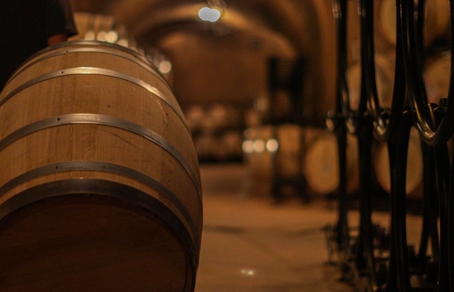Winemaking team tending to barrels