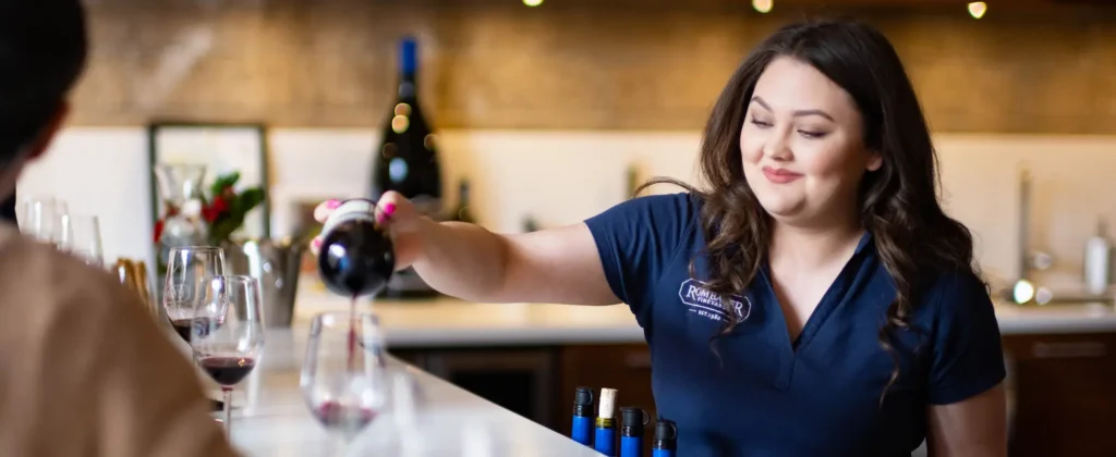 Employee pouring a glass of Rombauer wine
