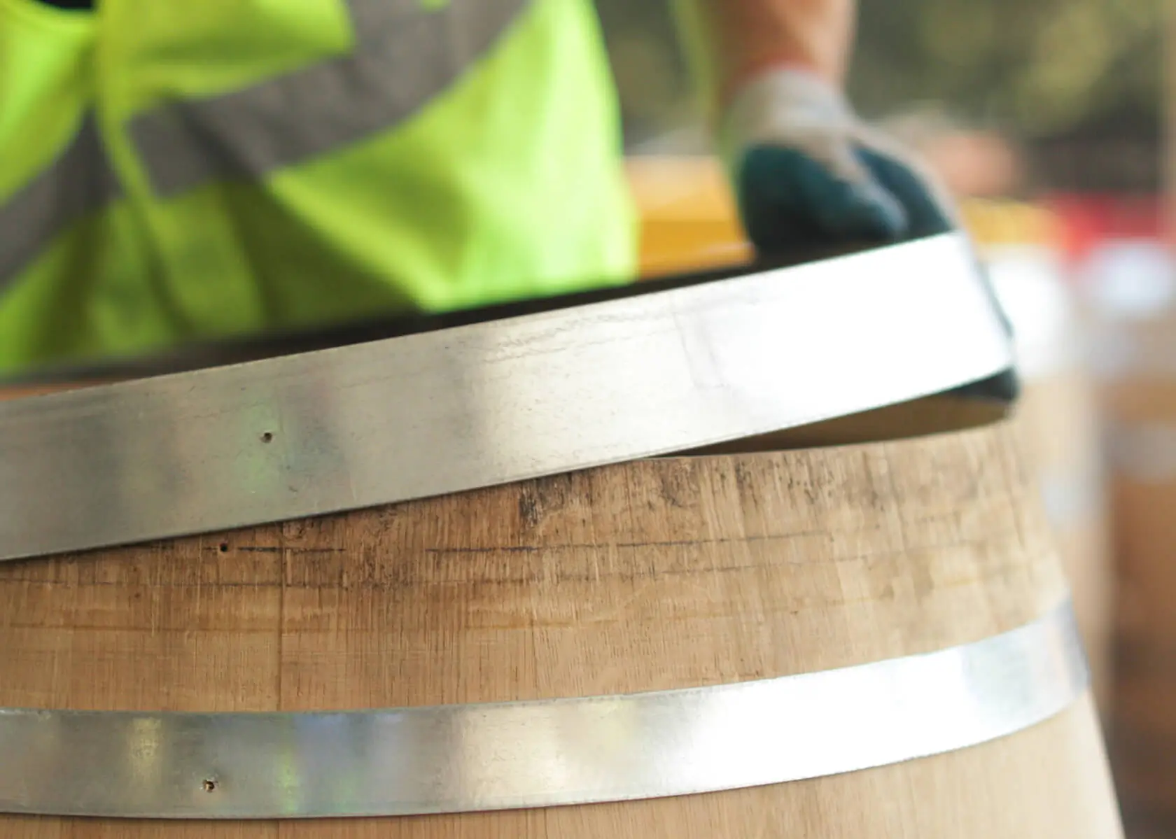 Person putting lid on wine barrell