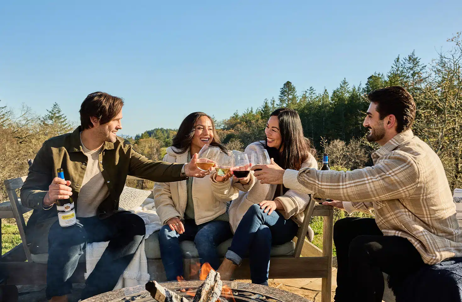 Group Cheers by the fire with Rombauer wine.