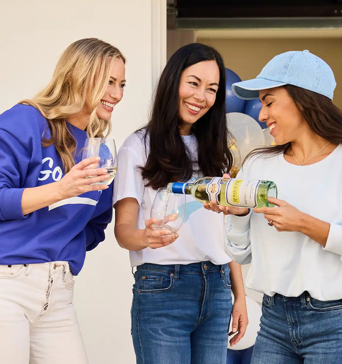 Woman pouring Sauvignon Blanc for her friends