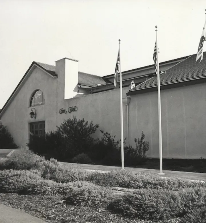 Black and white image of a winery building. 