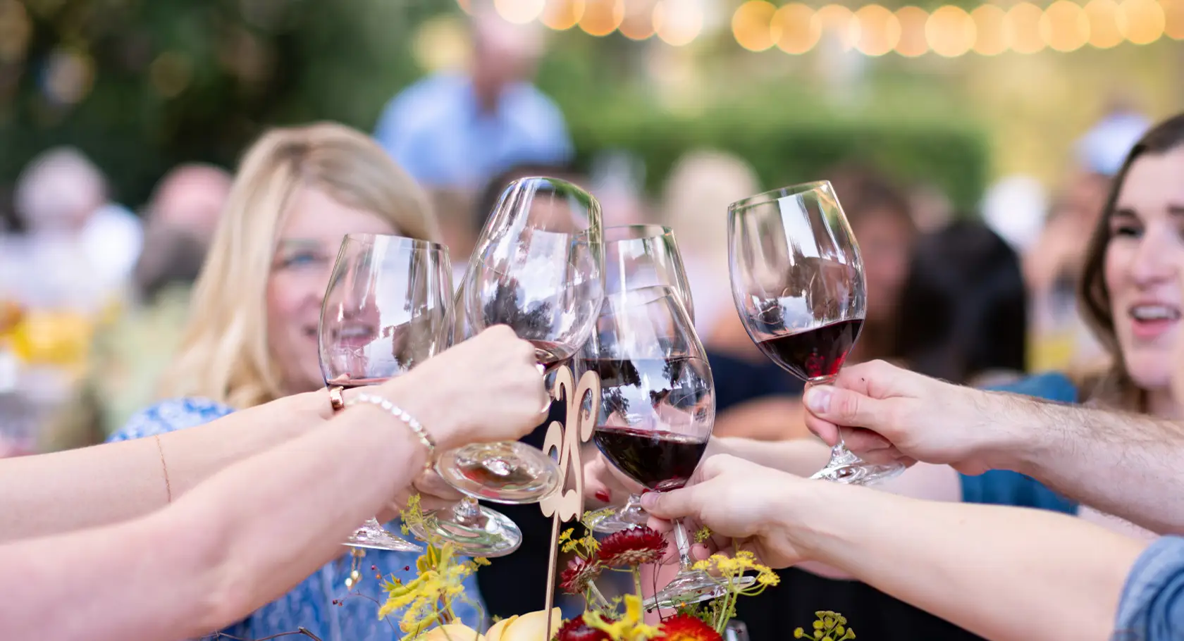 Group of customers toasting with glasses of Rombauer wine